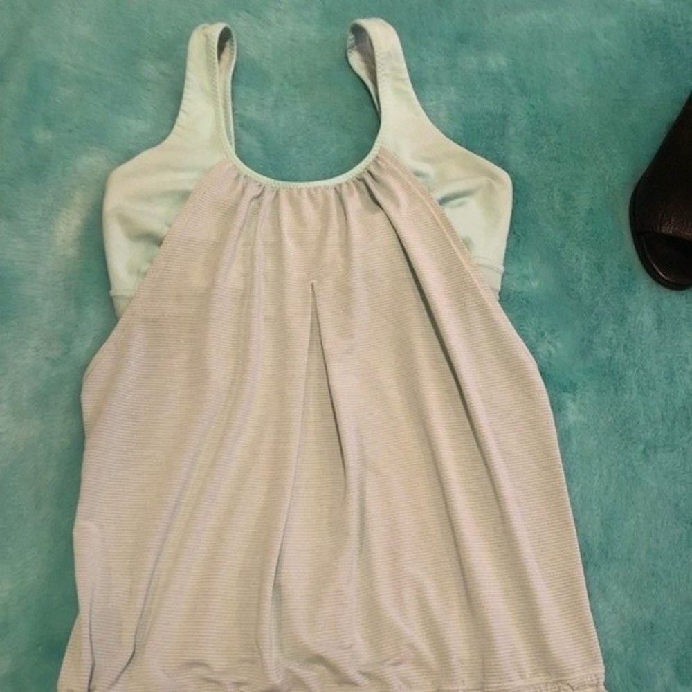 Mint green lululemon tank top with built in bra size 6, one snag on the back